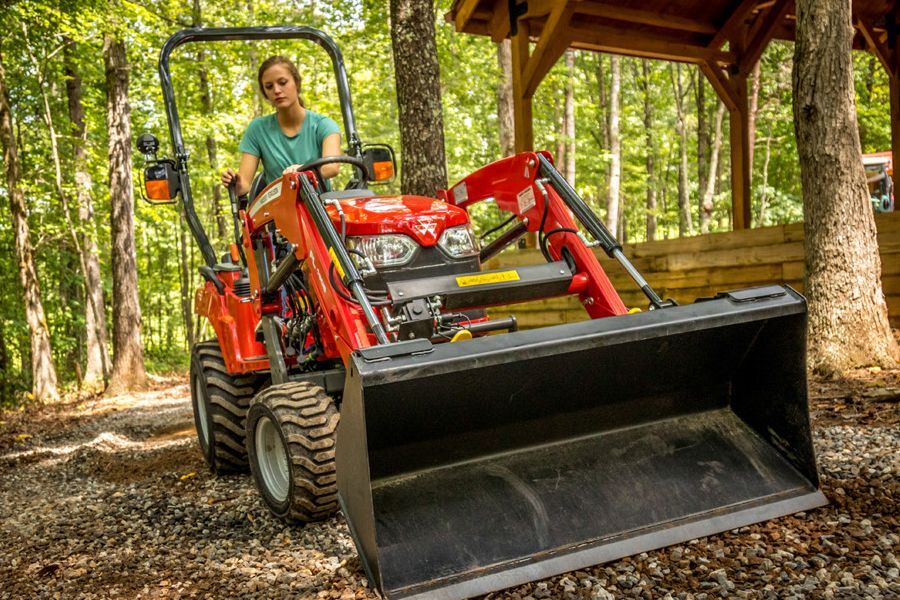 Woman riding the tractor with loader