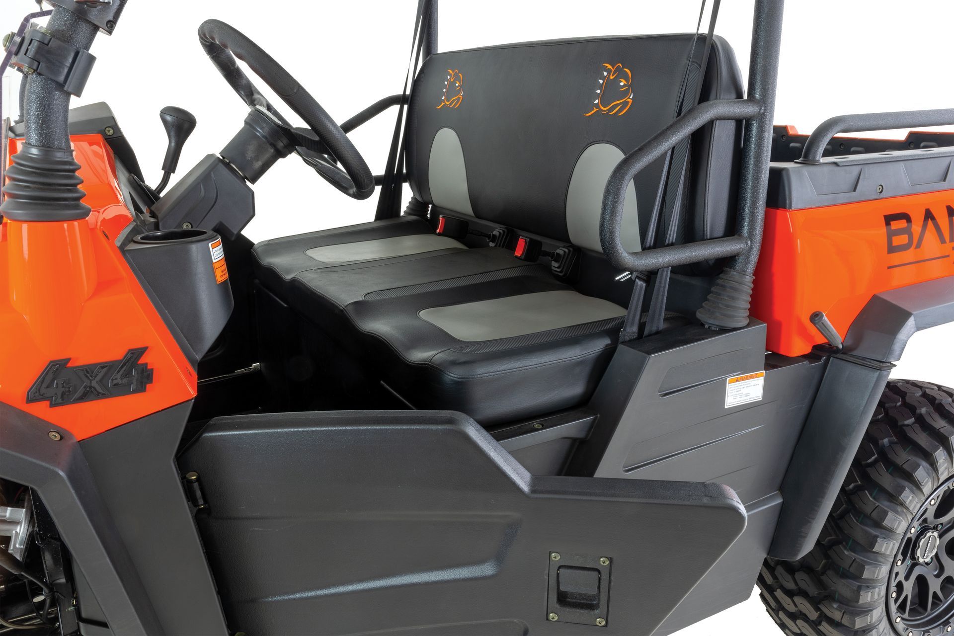 A black and orange utility vehicle with a steering wheel and seats