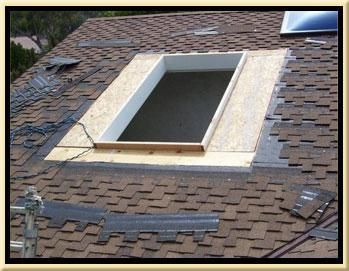 A skylight is being installed on the roof of a house