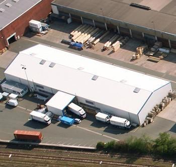 An aerial view of a warehouse with a new roof
