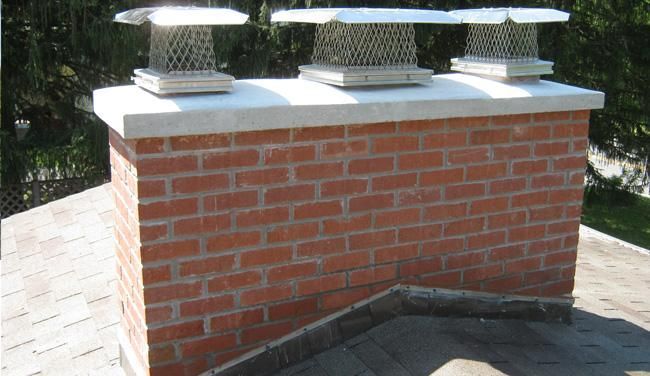 A brick chimney sitting on top of a roof