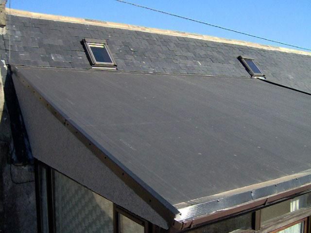 The roof of a house with two skylights on it