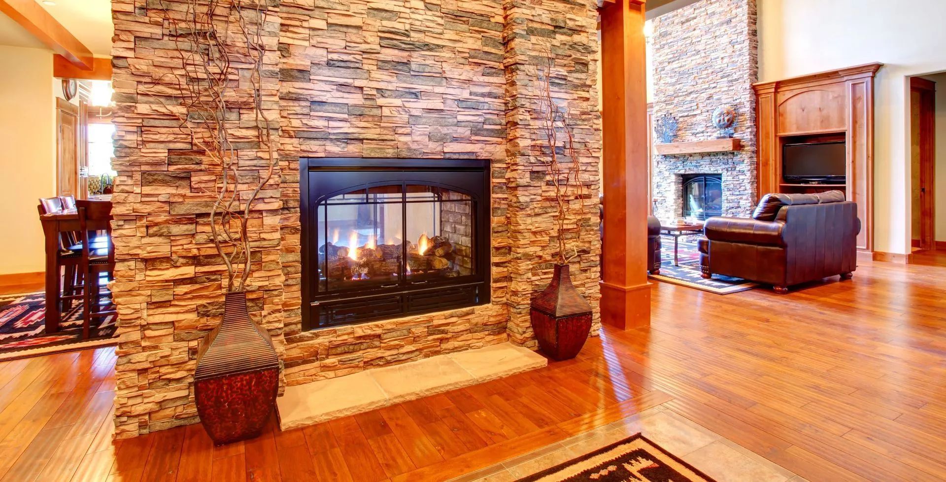 There is a fireplace in the middle of the living room.