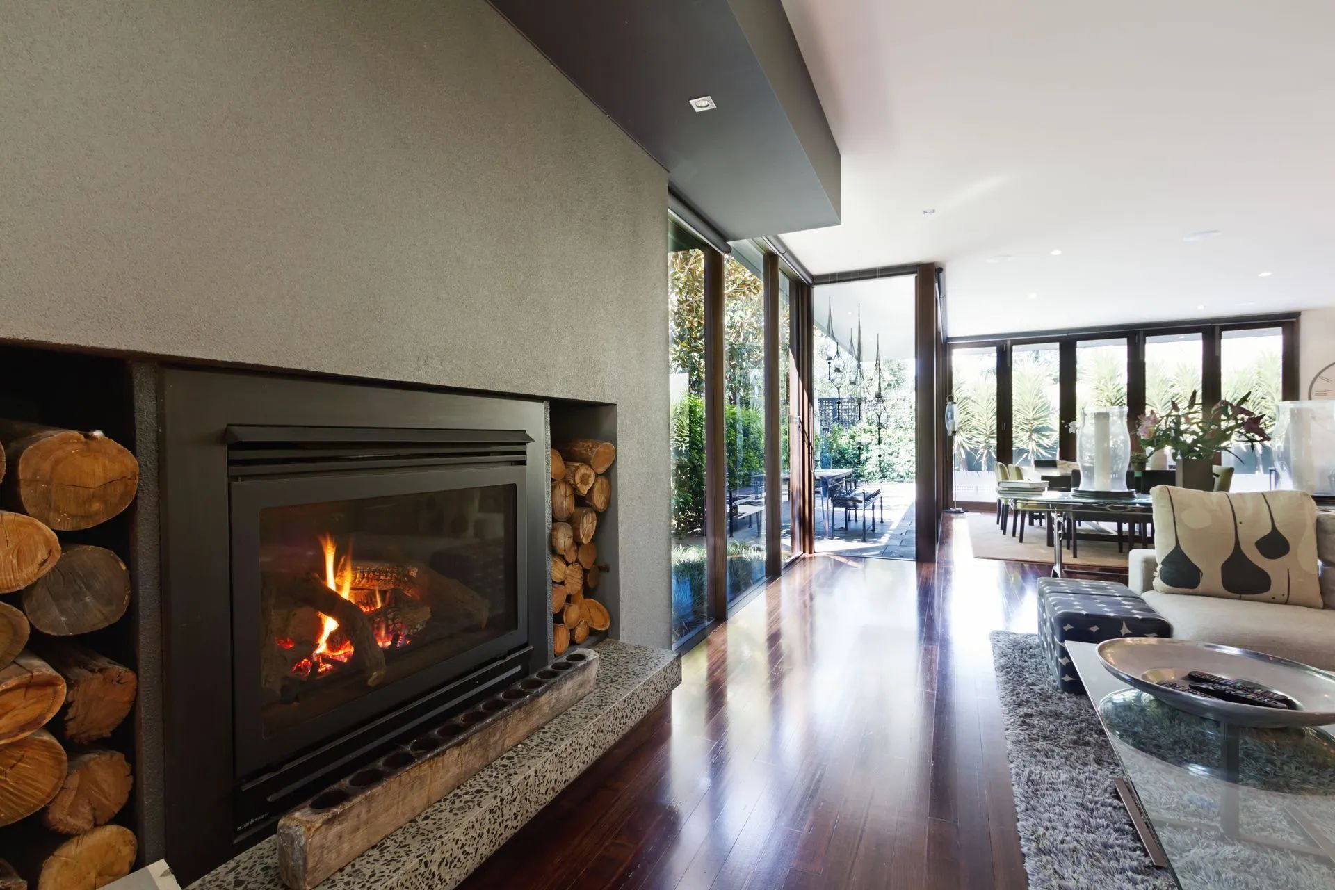 A living room with a fireplace and lots of windows