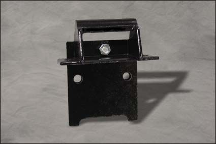 Black metal bracket with a top handle and two bolt holes on a gray surface.