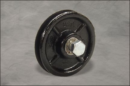Black metal pulley wheel with a silver hex bolt on a gray background