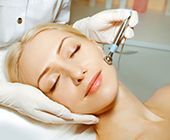 Woman getting skin care treatments by skin expert