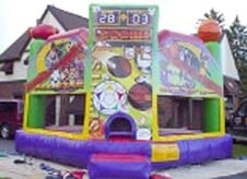 An inflatable basketball hoop is sitting in front of a house.