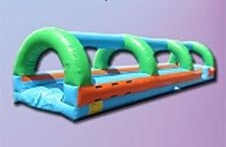 A large inflatable water slide is sitting on top of a purple surface.