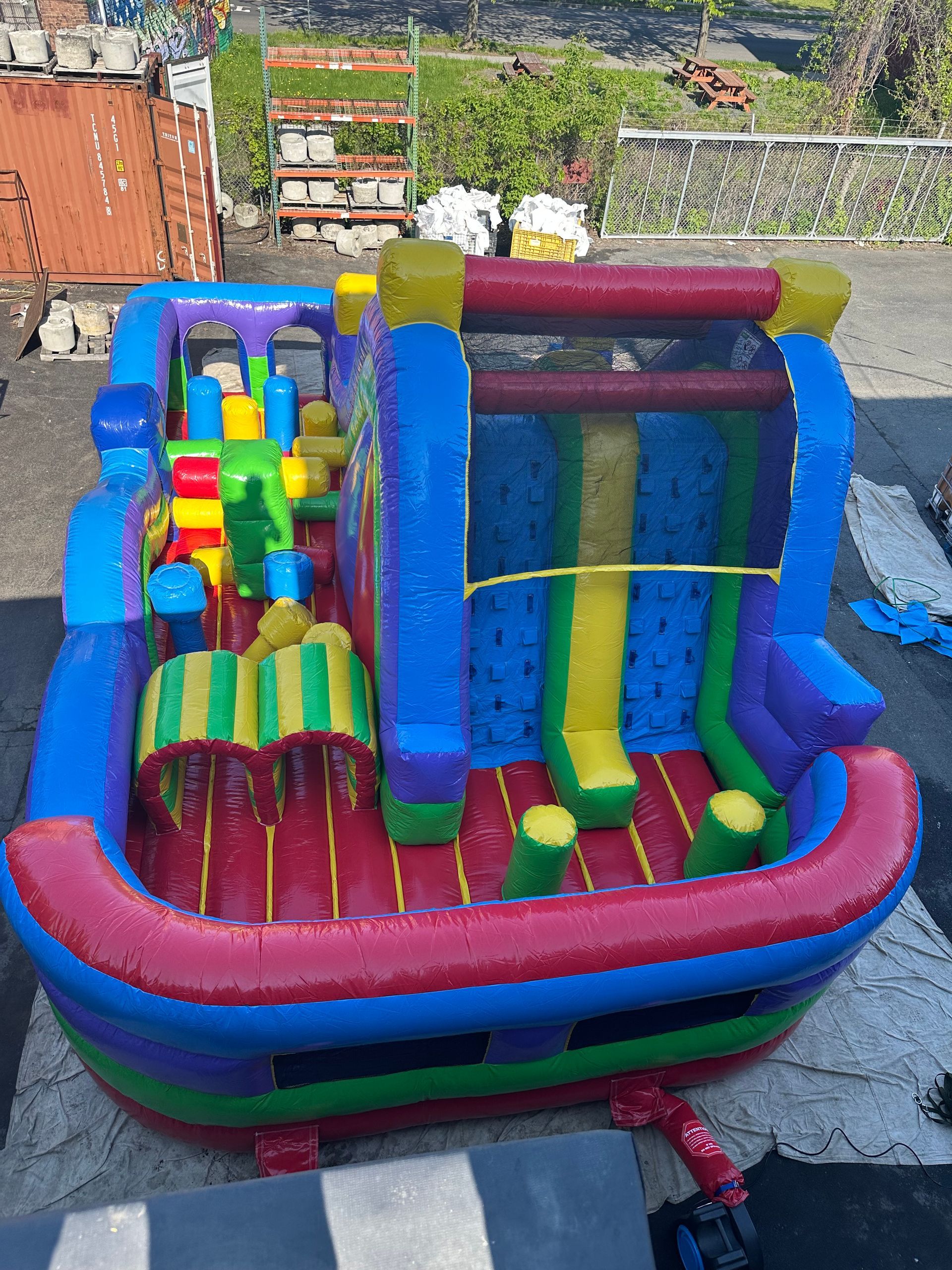 A large inflatable bouncy house is sitting on the ground in a parking lot.