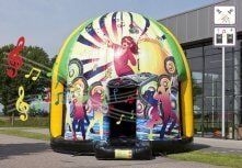 A large inflatable dome with a picture of people dancing and music notes on it.
