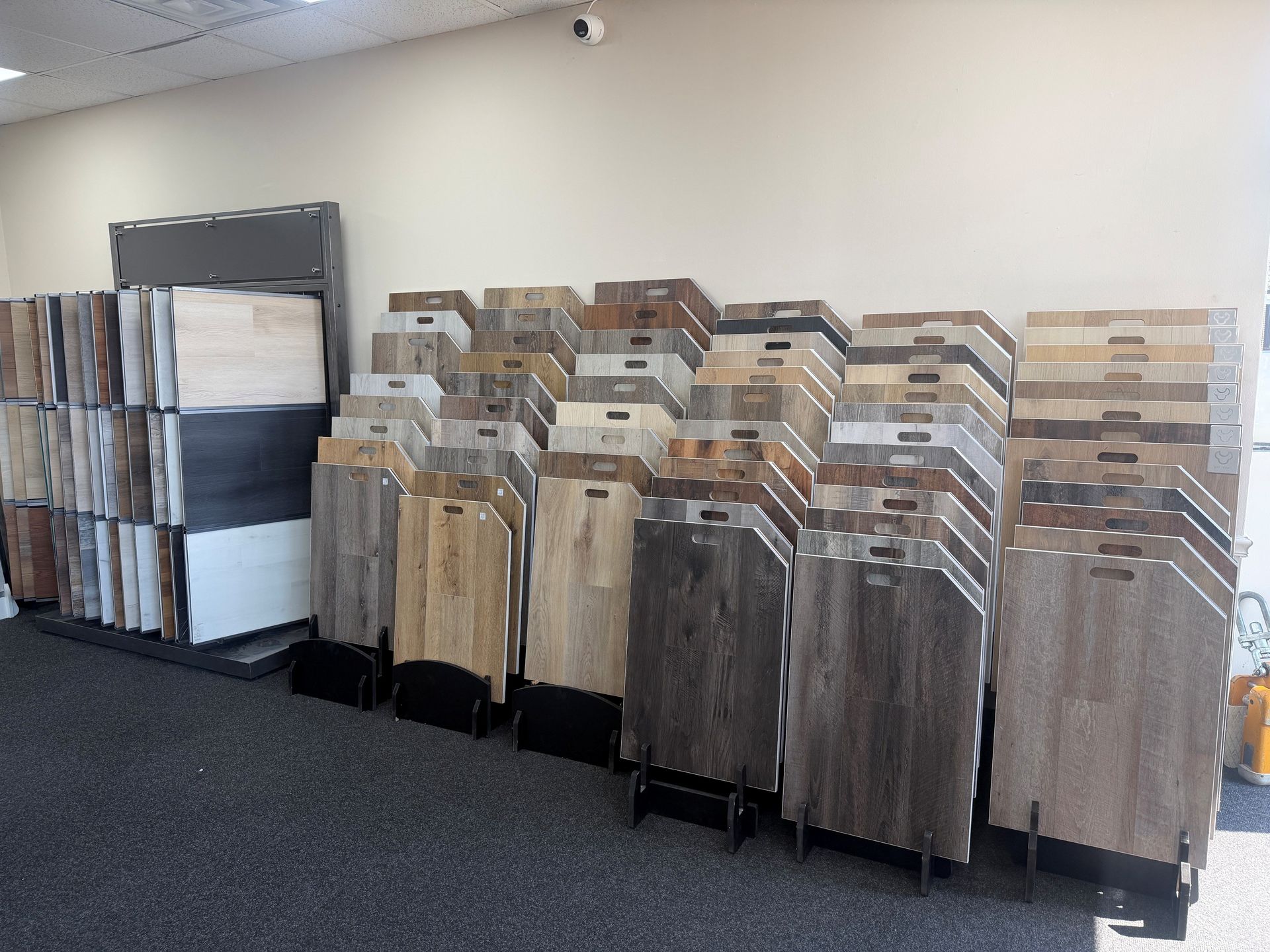 Stacks of sample boards lined up in a carpeted showroom or office room.