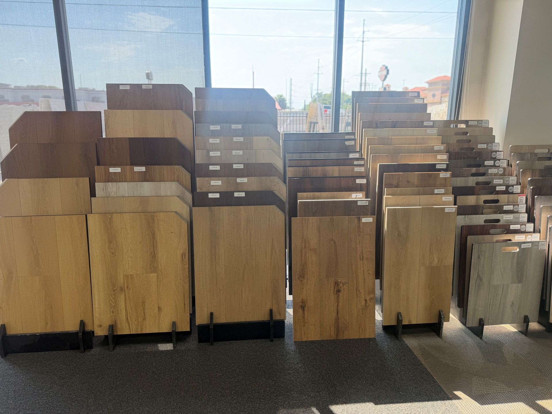 Stacked wooden boxes and cabinets in a bright indoor space near large windows.