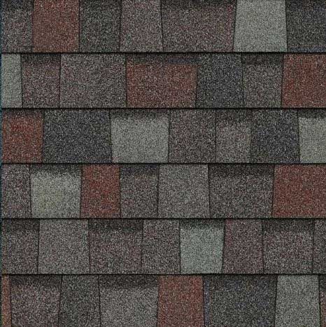 Close-up view of asphalt roof shingles in shades of gray, red, and brown.