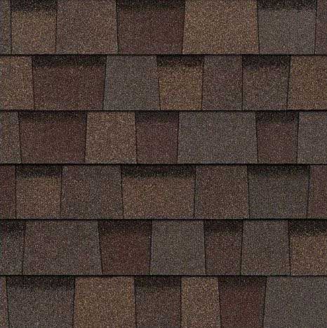 Brown asphalt roof shingles in varying shades, creating a textured pattern.