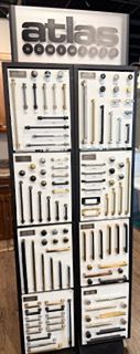 A display case filled with lots of different types of handles and knobs.