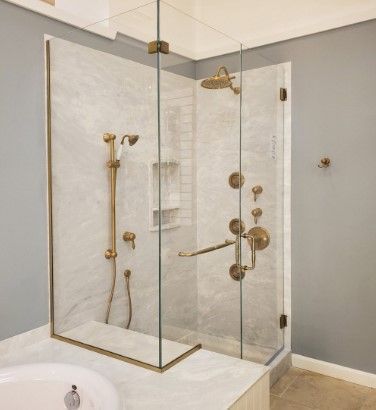 A bathroom with a shower with a glass door