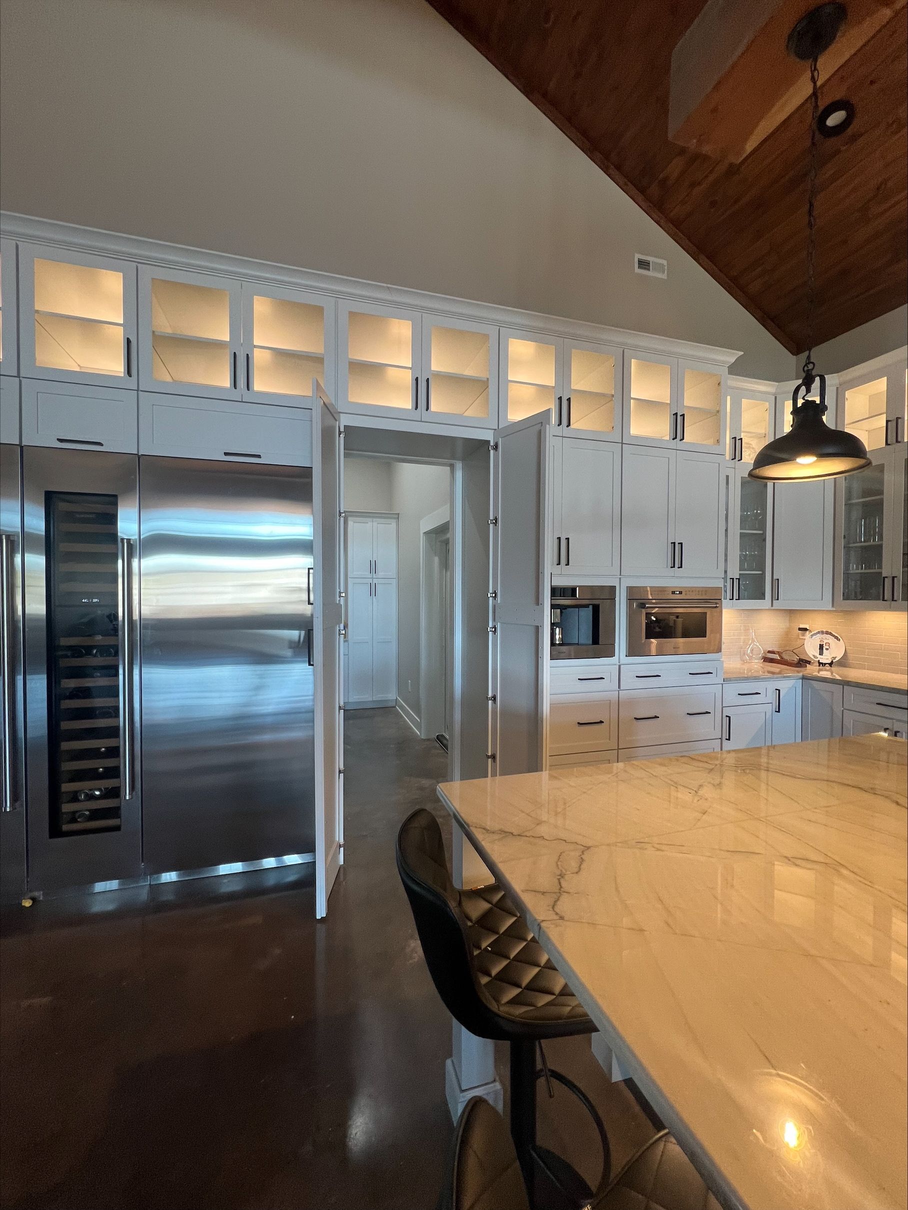 A kitchen with stainless steel appliances and white cabinets
