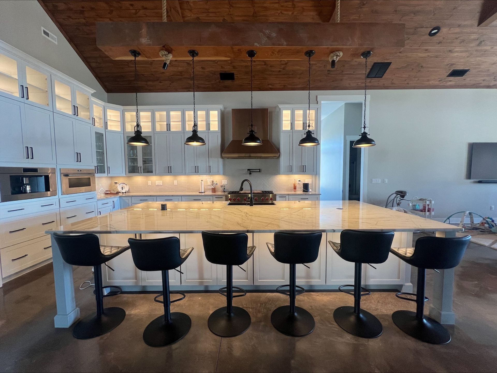 A large kitchen with a large island and stools.