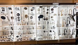 A display case filled with lots of different types of faucets.