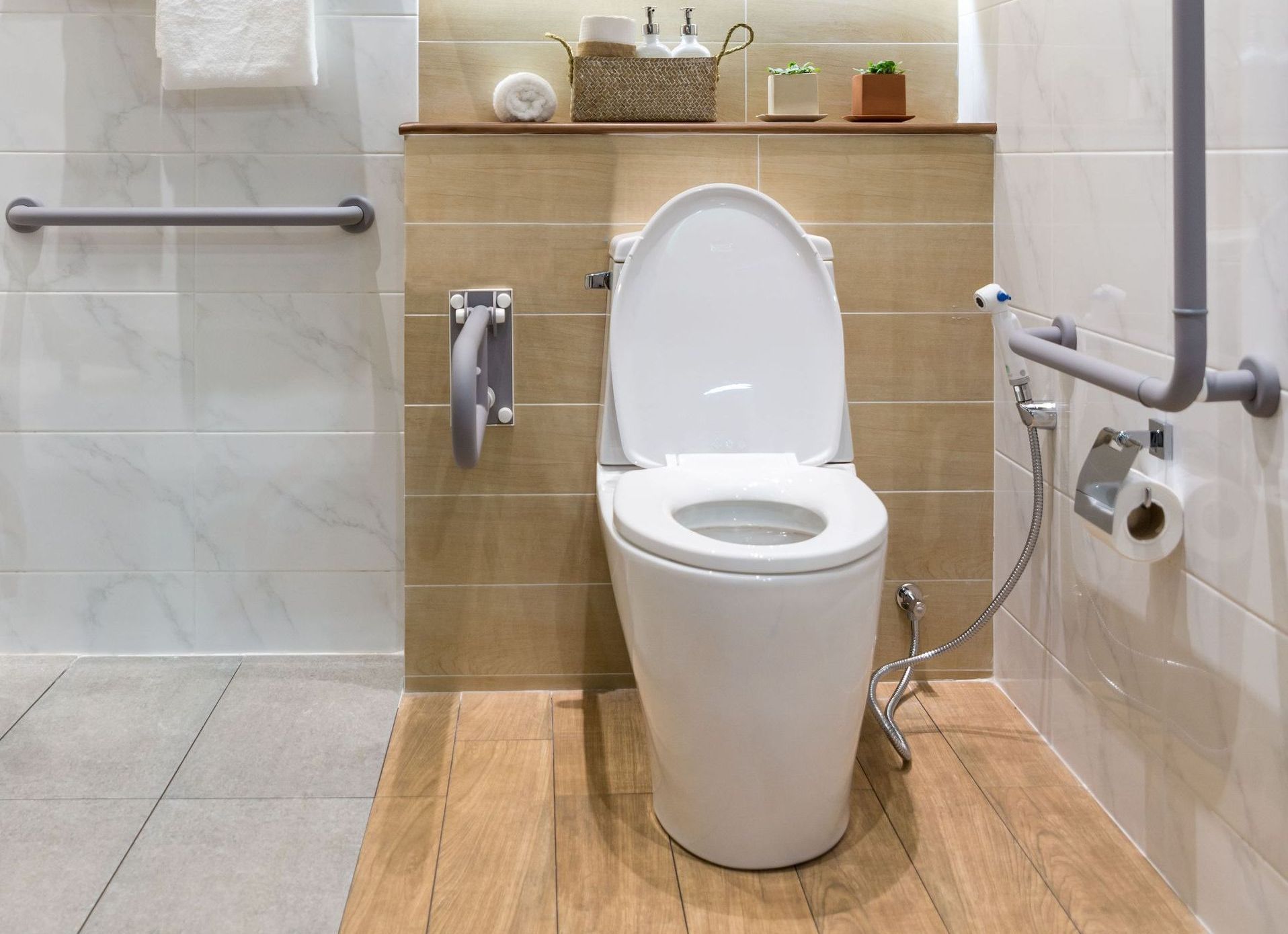 A bathroom with a toilet , sink and mirror.
