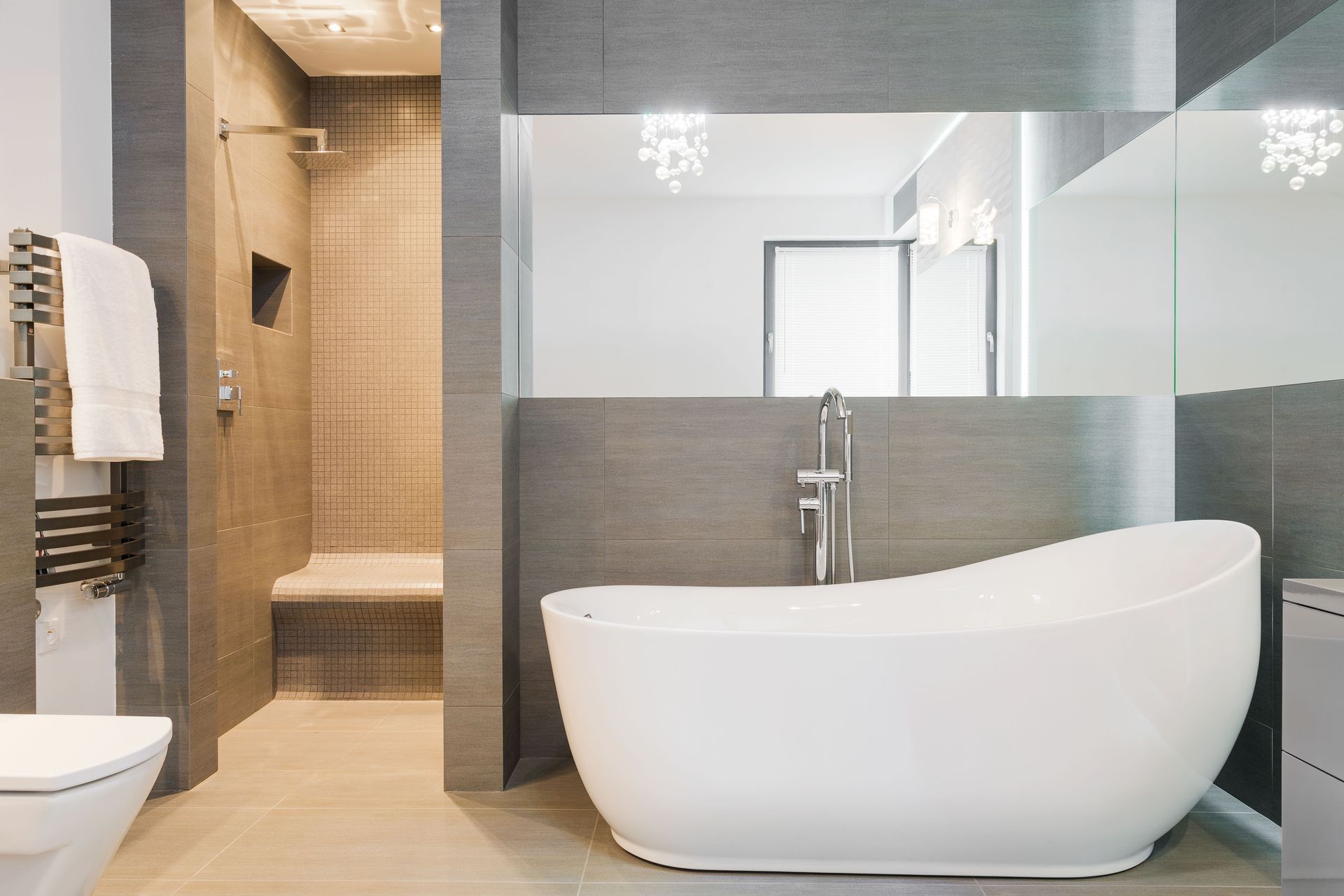 A bathroom with a bathtub , toilet , and shower.