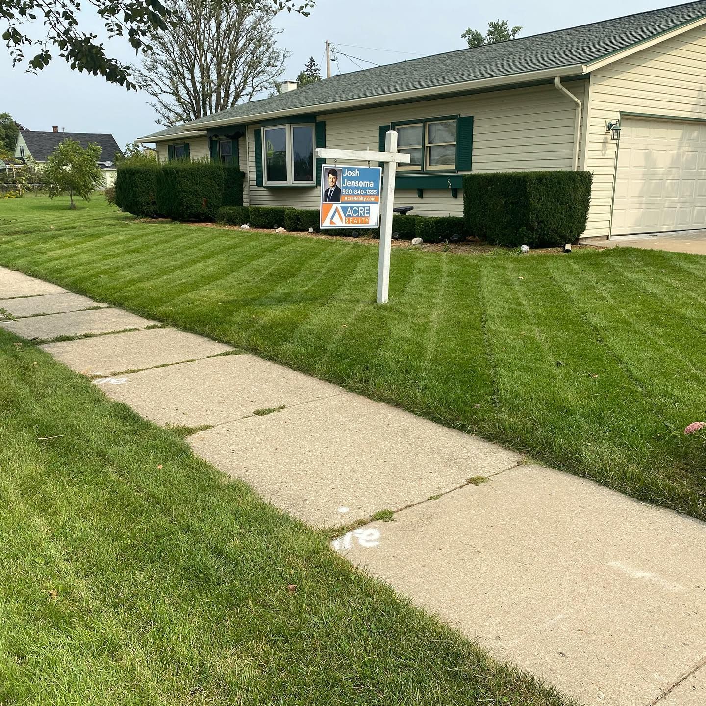 A house with a for sale sign in front of it