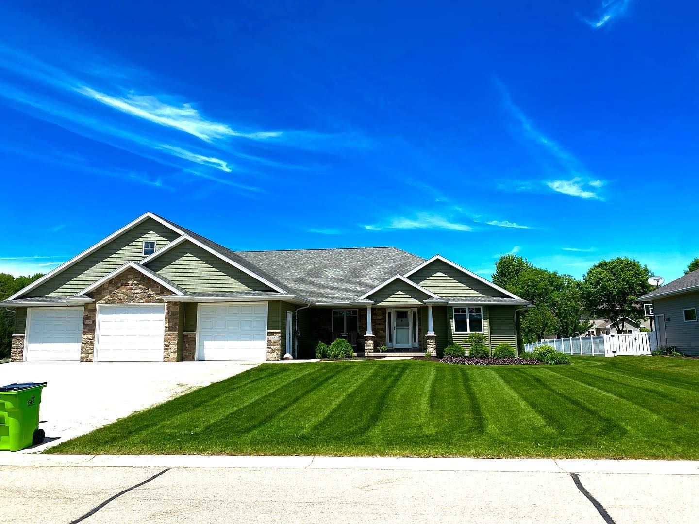 A large house with a lush green lawn in front of it.