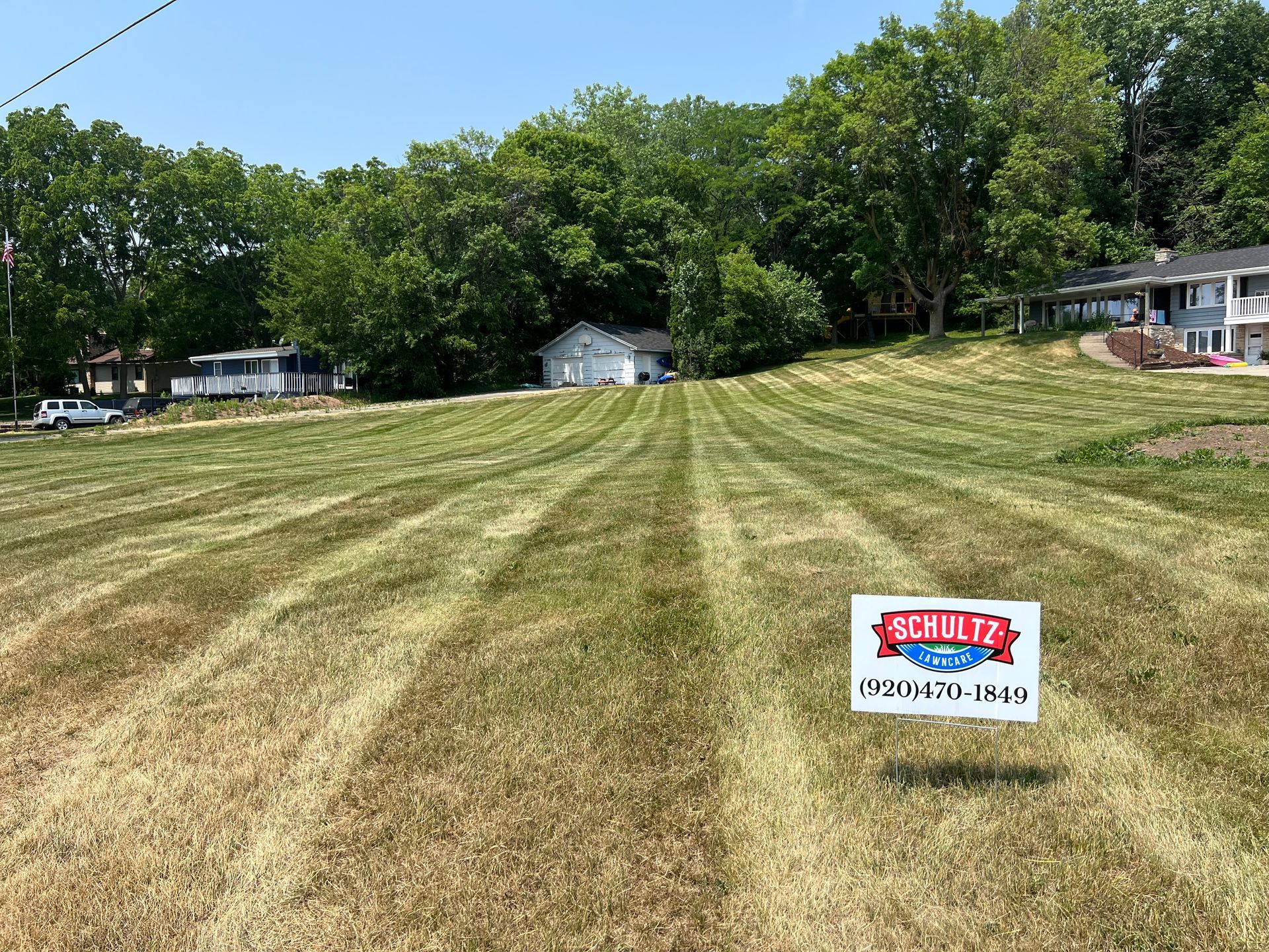 A lush green lawn with a sign in the middle of it.