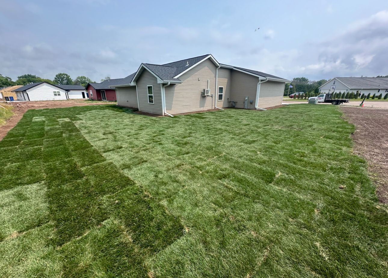 A house with a lot of grass in front of it.