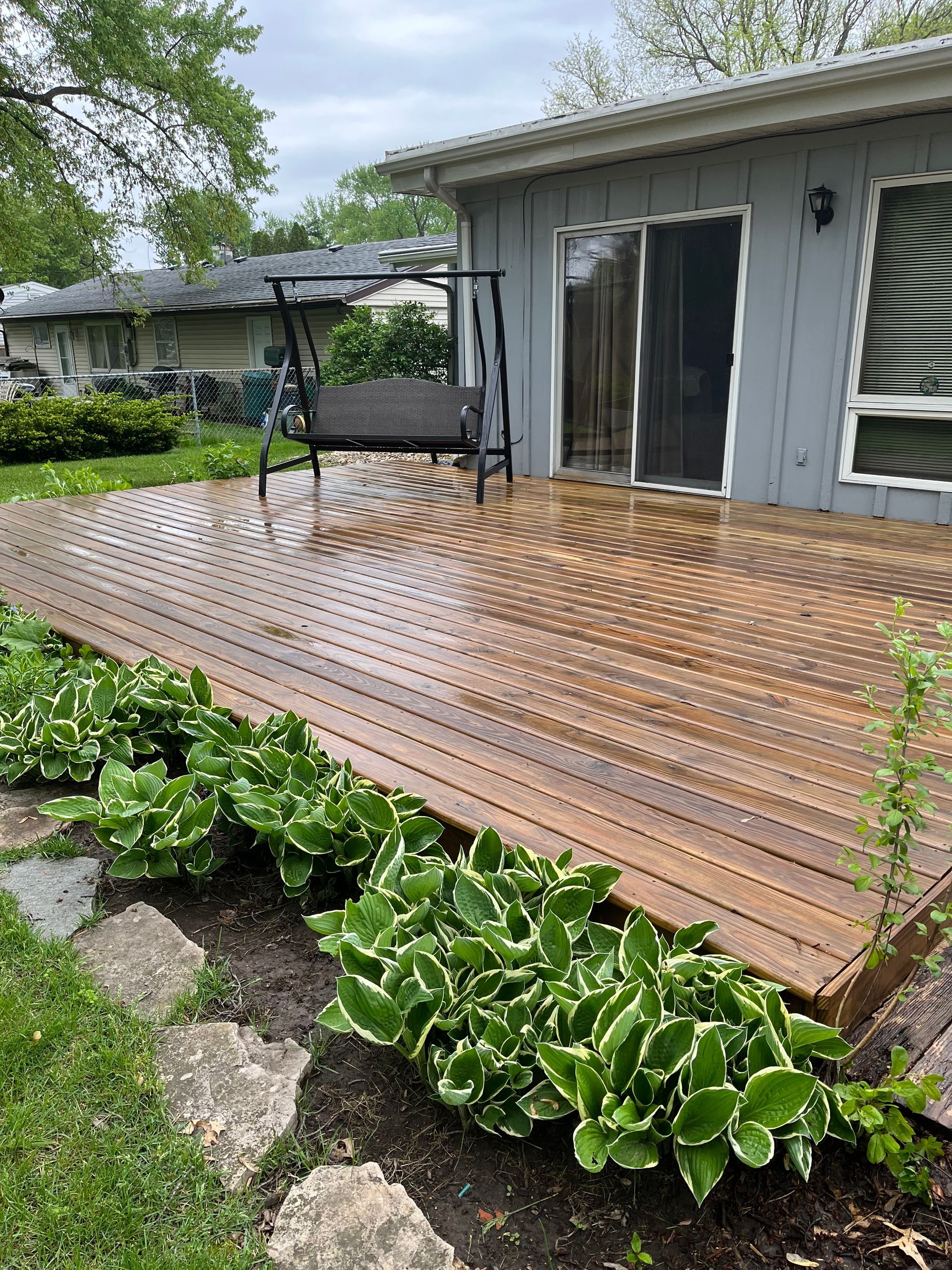 wooden deck gray house - after