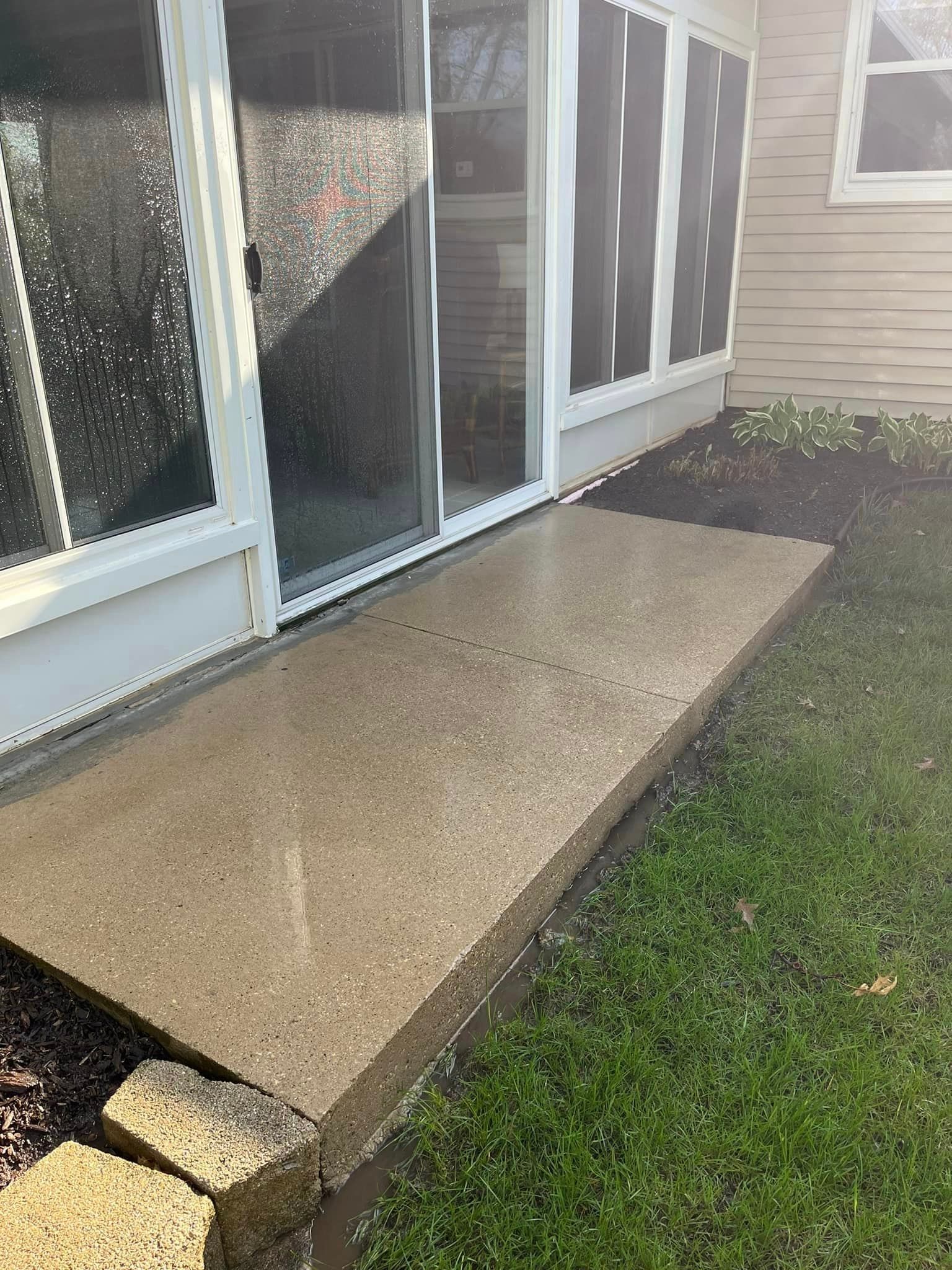 dirty sidewalk in front of a house with a sliding glass door - after