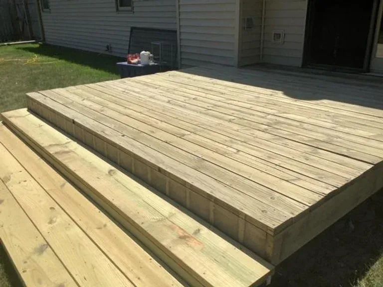 wooden deck white house - after