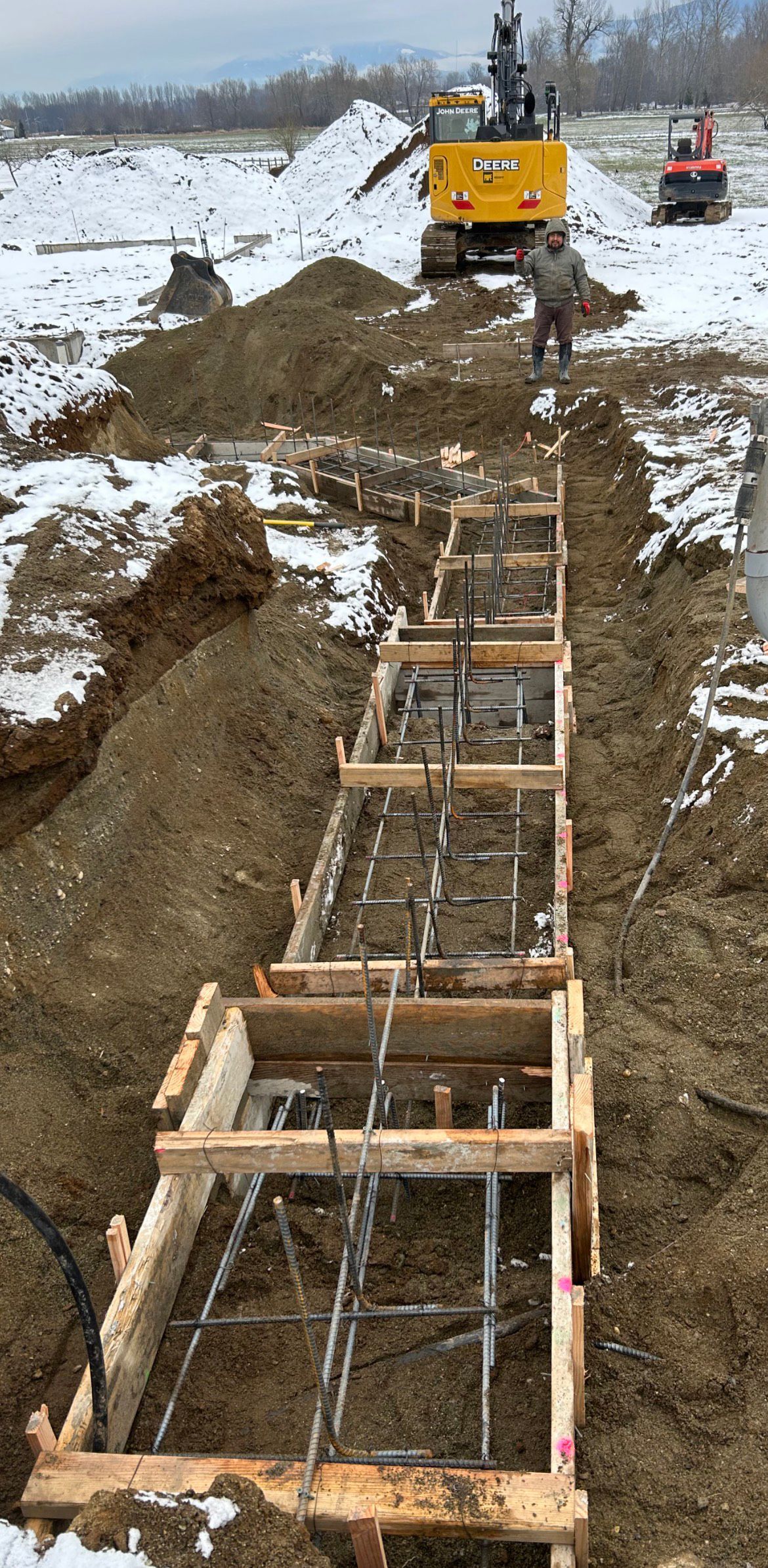 Wooden forms and steel reinforcement on a snowy day