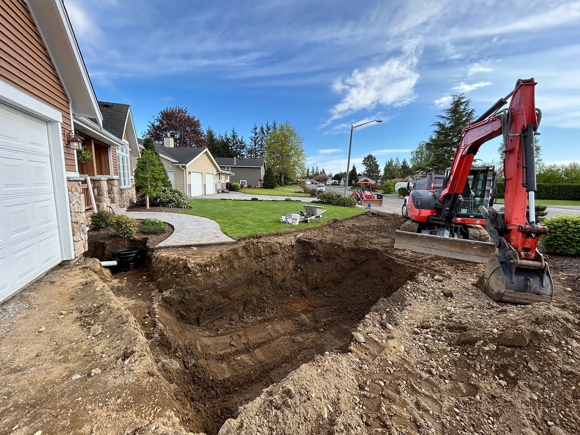 Excavator preparing ground under home garden