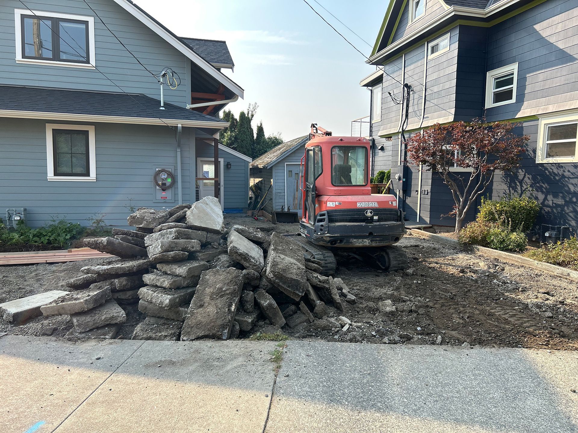 Mini excavator outside a house