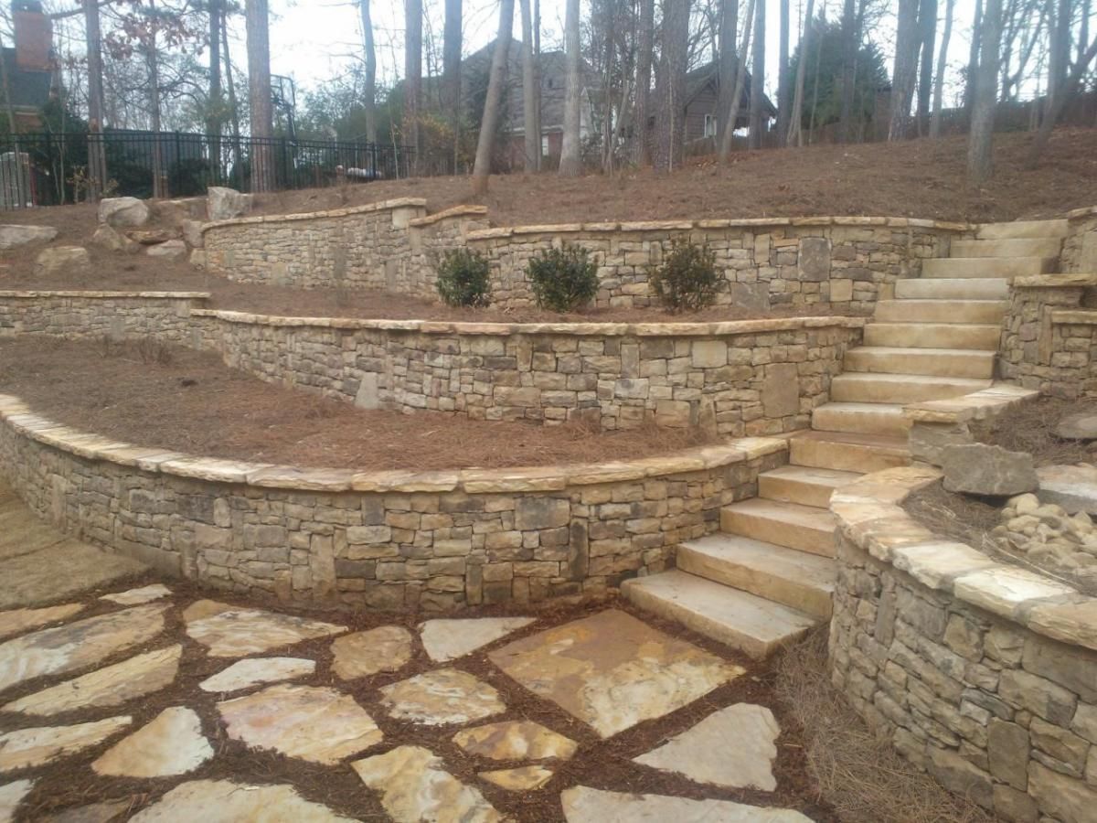 a stone wall with stairs leading up to it