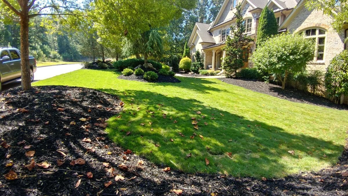 a large house with a lush green lawn and a truck parked in front of it .