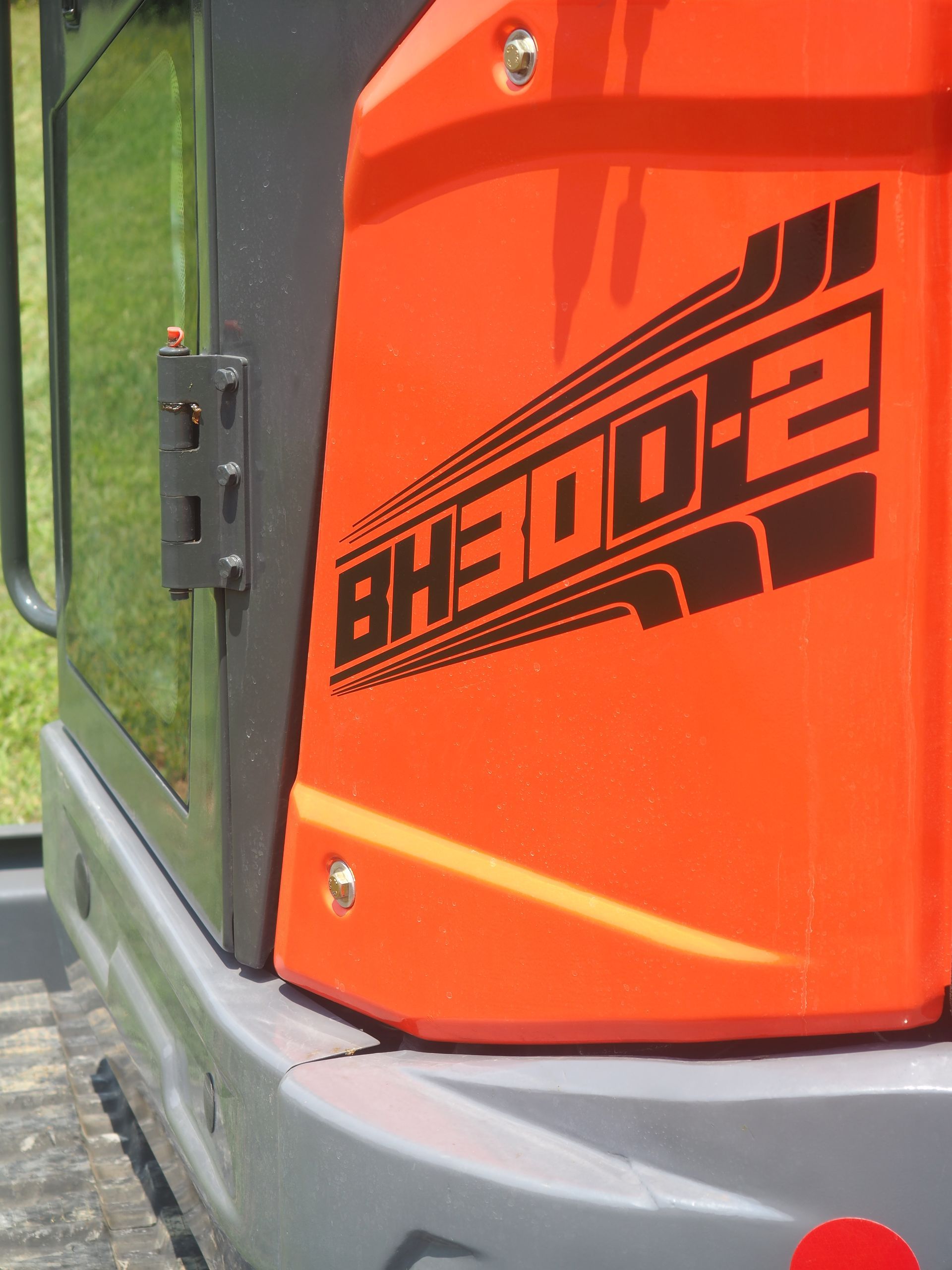 Orange and gray compact excavator, model BH300-2.