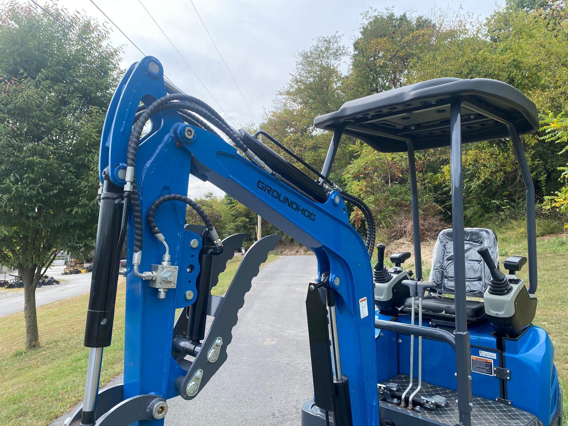 Blue mini excavator outdoors.
