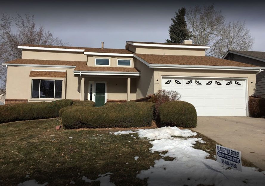 Residential house with a light brown coat of stucco