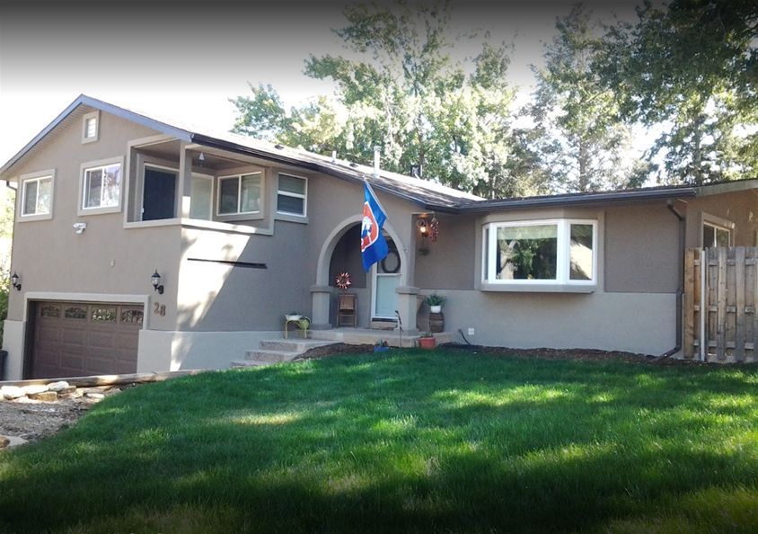 Residential house with a gray coat of stucco
