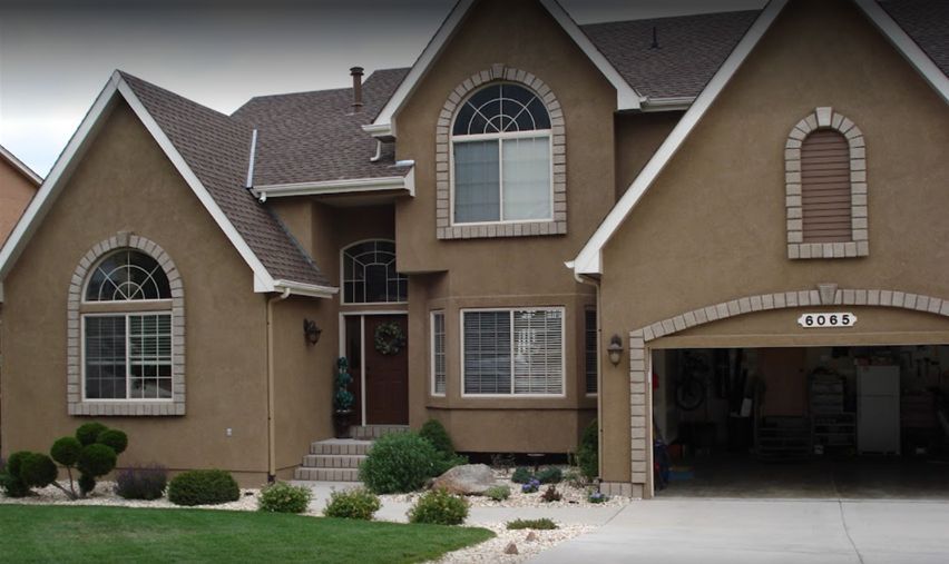 Residential house with a brown coat of stucco