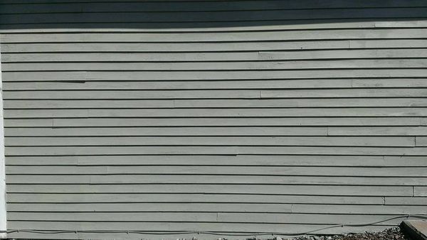A close up of a gray siding on a house.