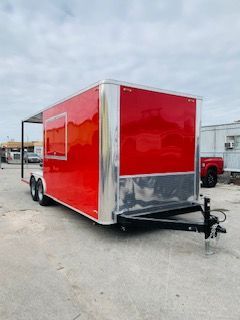 Red enclosed utility trailer with silver trim parked on a lot