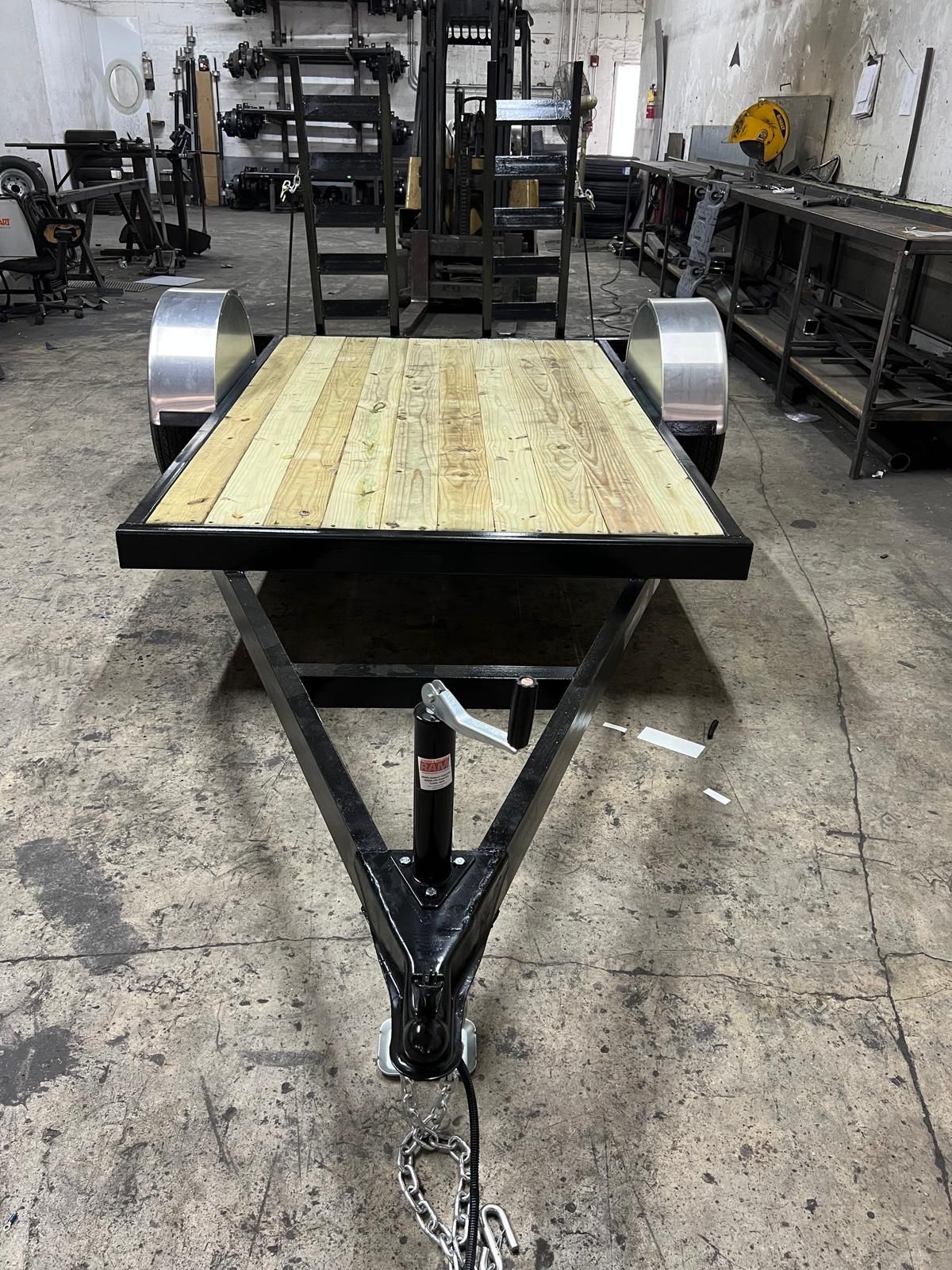 Steel utility cart with a wooden top in an industrial workshop