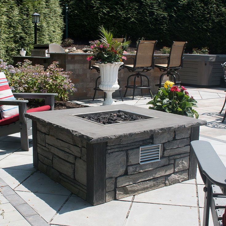 A fire pit sits in the middle of a patio