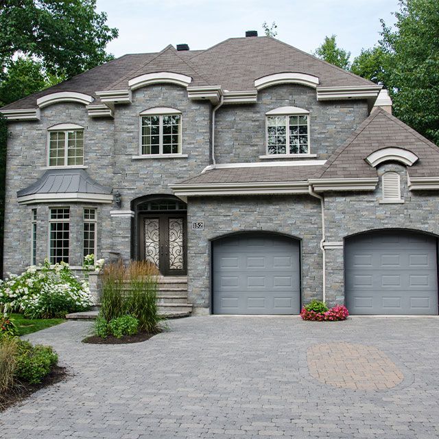 A large brick house with two garage doors