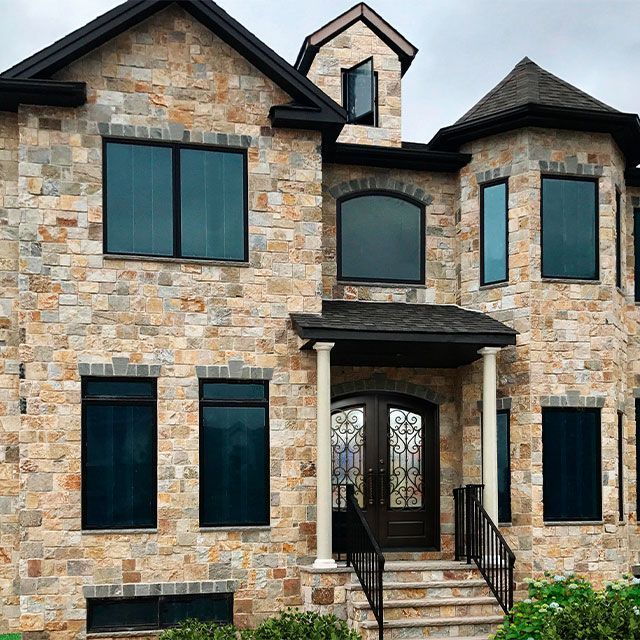 A large brick house with lots of windows and stairs