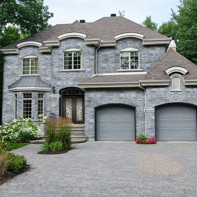A large brick house with two garage doors